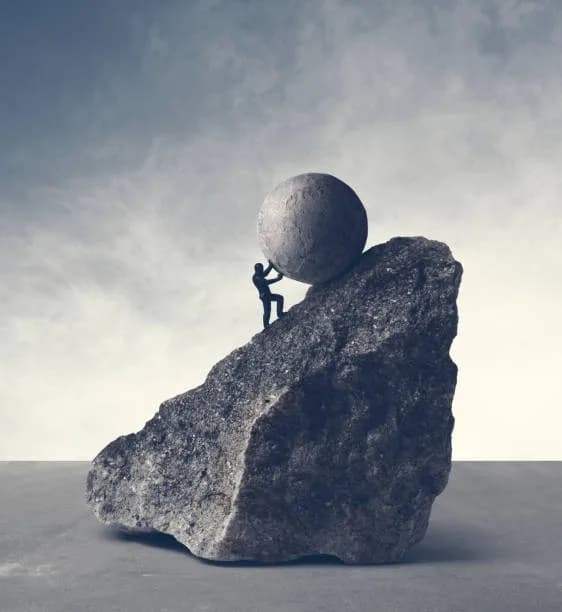 Person sitting on a rock representing reflection, resilience and mental wellbeing