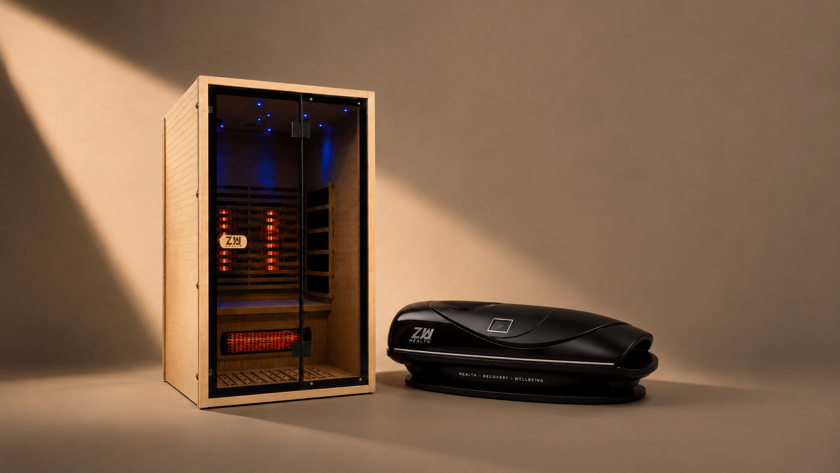 A Zua infrared sauna and a black Zua Therapy Pod in a warm studio, lit by a shaft of daylight